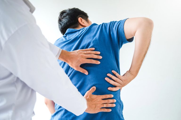 Doctor evaluating patient for back pain stem cell therapy